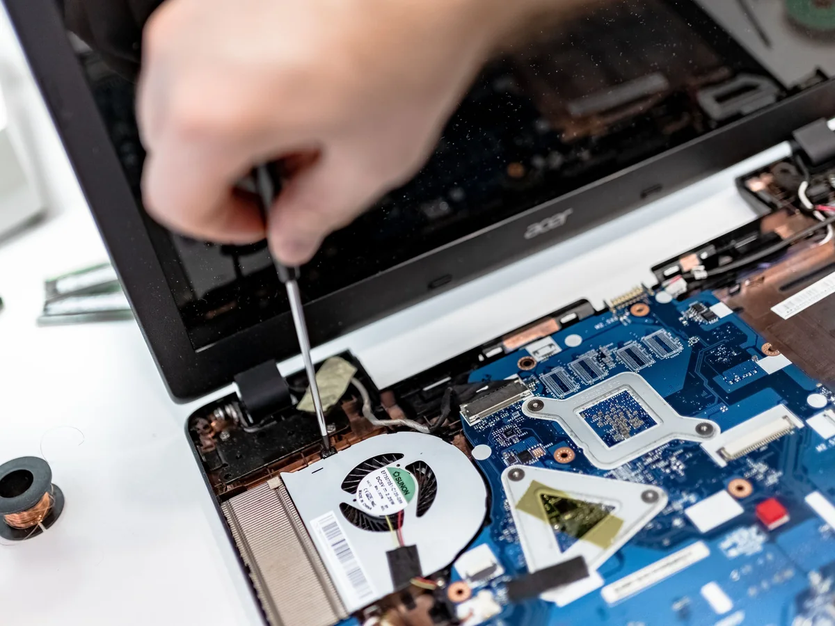 Laptop motherboard repair with precision screwdriver